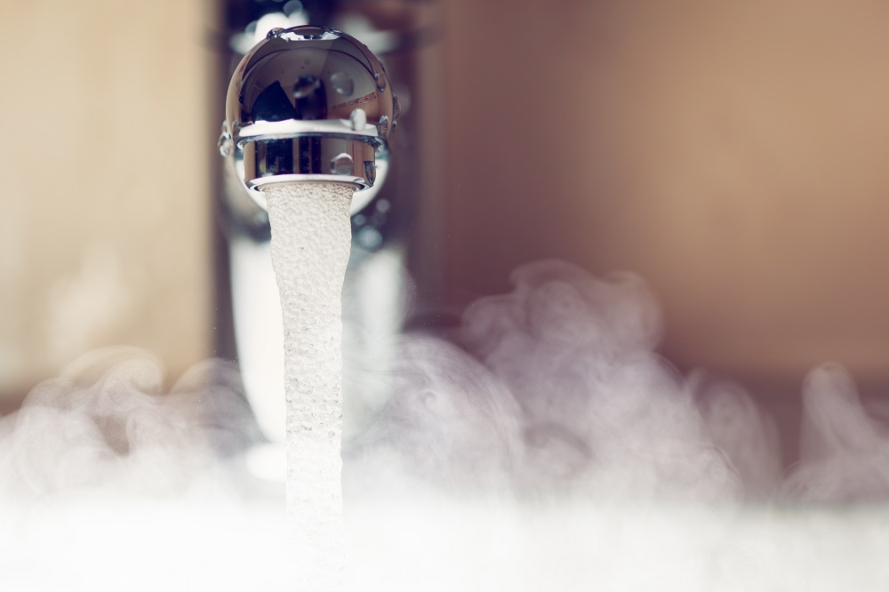Close-up of hot water from a faucet which represents "hot water system Australian standards" blog.